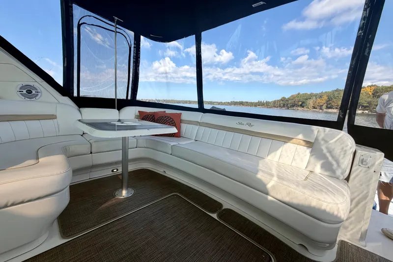  Yacht Photos Pics Luxurious interior of 2009 Sea Ray 48 Sundancer yacht with white seating and scenic lake view.