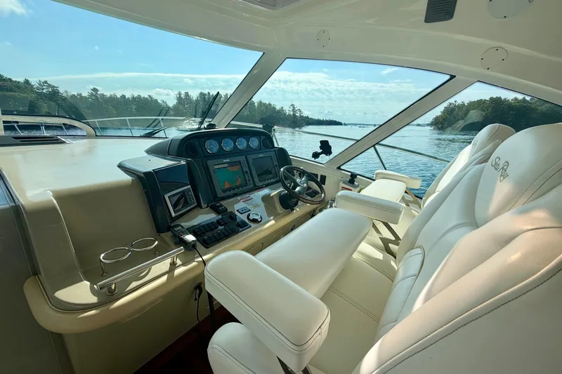  Yacht Photos Pics Interior helm of 2009 Sea Ray 48 Sundancer yacht with navigation controls and plush seating.