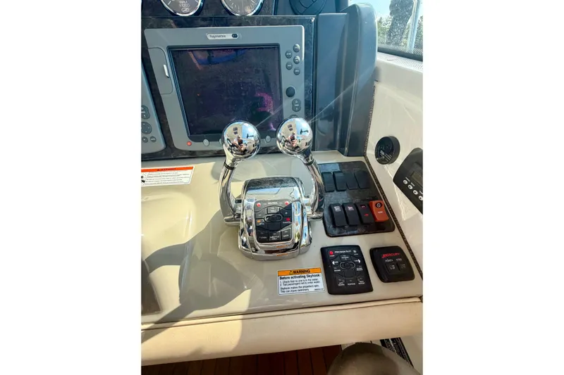  Yacht Photos Pics Control panel of 2009 Sea Ray 48 Sundancer yacht with navigation and throttle controls.