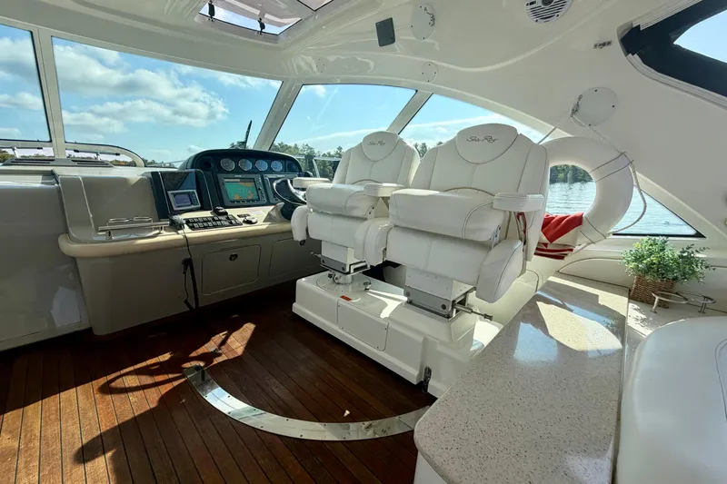  Yacht Photos Pics Luxurious 2009 Sea Ray 48 Sundancer yacht interior with helm and plush seating.