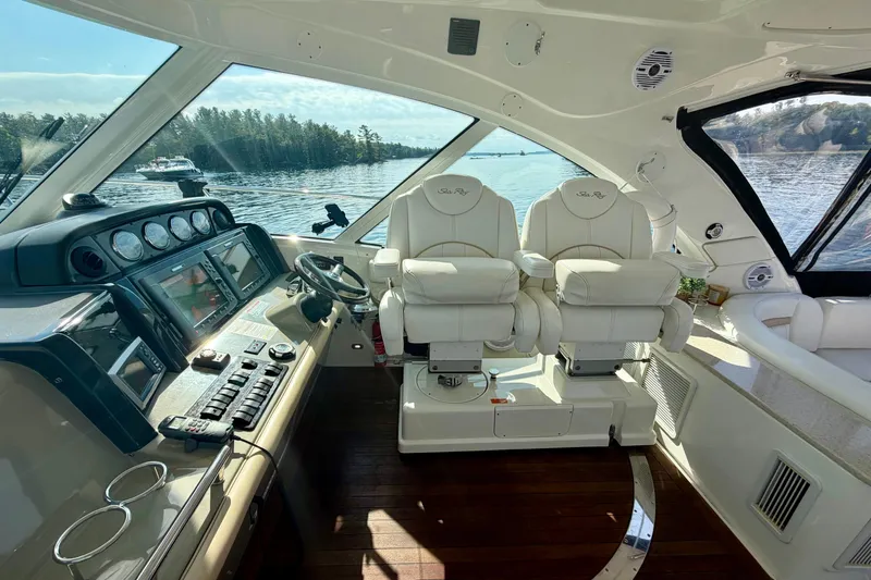  Yacht Photos Pics Luxurious 2009 Sea Ray 48 Sundancer yacht interior with dual captain's chairs and advanced dashboard.