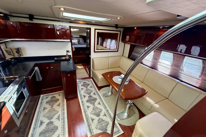  Yacht Photos Pics Luxurious interior of 2009 Sea Ray 48 Sundancer yacht with elegant seating and modern kitchen.