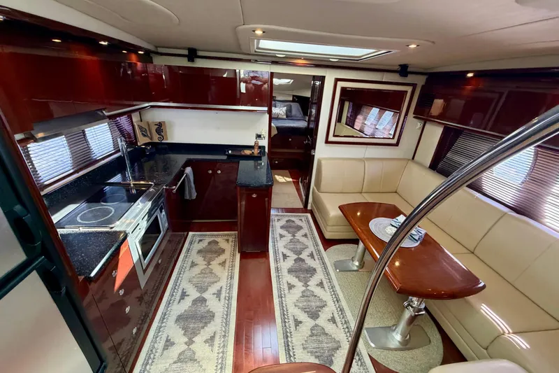  Yacht Photos Pics Luxurious interior of 2009 Sea Ray 48 Sundancer yacht with kitchen and seating area.