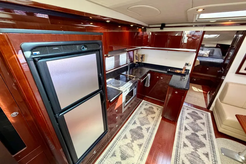  Yacht Photos Pics Luxurious 2009 Sea Ray 48 Sundancer yacht interior with modern kitchen and elegant wood finishes.