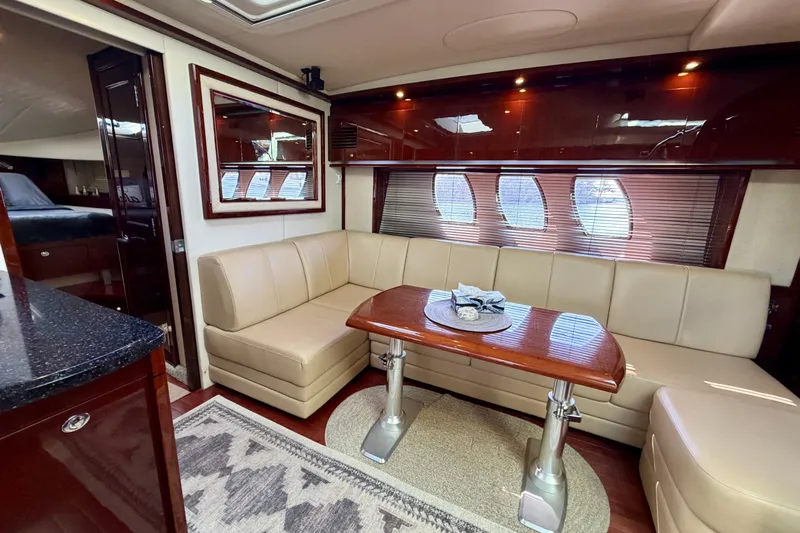  Yacht Photos Pics Luxurious interior of 2009 Sea Ray 48 Sundancer yacht with elegant seating and wooden table.