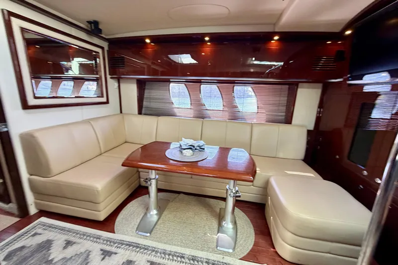  Yacht Photos Pics Luxurious interior of 2009 Sea Ray 48 Sundancer yacht with elegant seating and table.