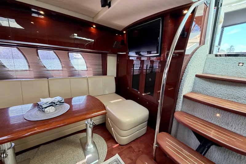  Yacht Photos Pics Luxurious interior of 2009 Sea Ray 48 Sundancer yacht with elegant seating and wooden accents.