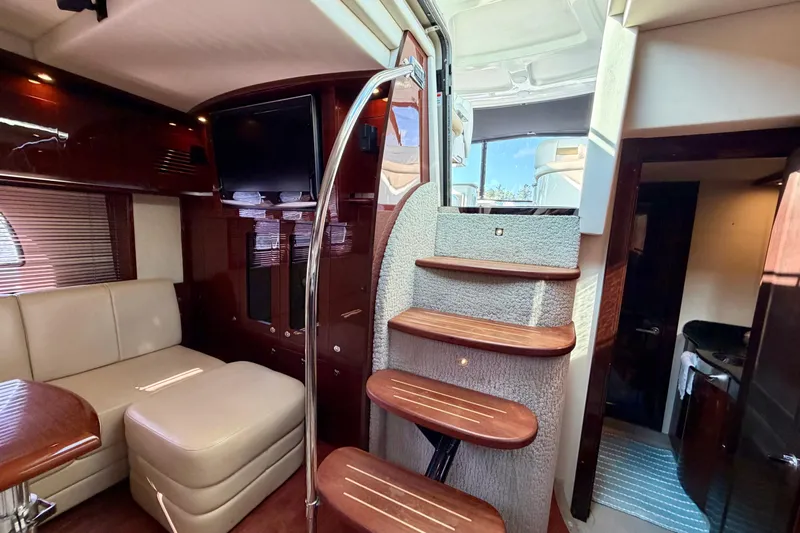  Yacht Photos Pics Luxurious interior of 2009 Sea Ray 48 Sundancer yacht with elegant staircase and seating area.