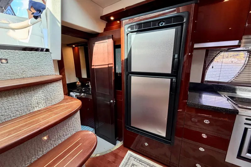  Yacht Photos Pics Interior of 2009 Sea Ray 48 Sundancer yacht with kitchen and staircase.
