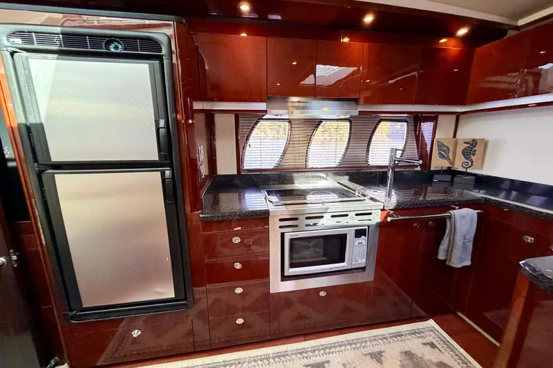  Yacht Photos Pics Luxurious kitchen interior of 2009 Sea Ray 48 Sundancer yacht with modern appliances.