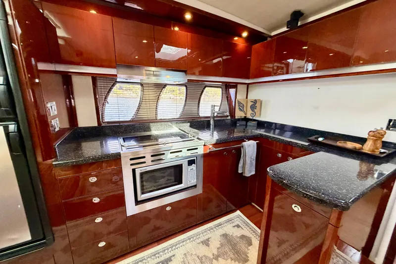  Yacht Photos Pics Luxurious kitchen interior of 2009 Sea Ray 48 Sundancer yacht with sleek cabinetry and modern appliances.