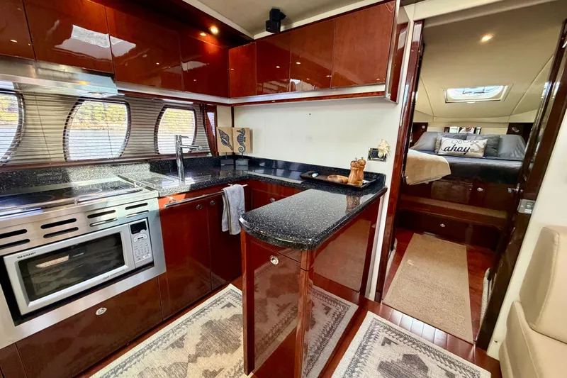  Yacht Photos Pics Luxurious 2009 Sea Ray 48 Sundancer yacht interior with modern kitchen and cozy bedroom.