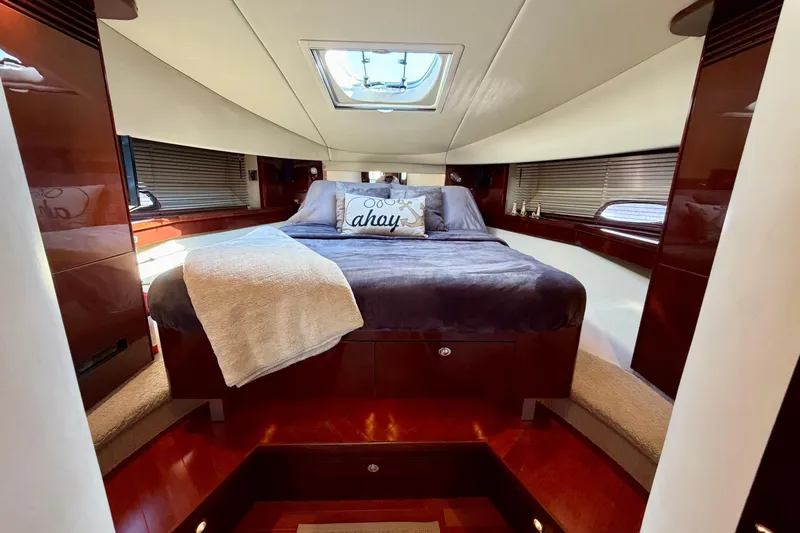  Yacht Photos Pics Luxurious 2009 Sea Ray 48 Sundancer cabin with plush bedding and elegant wood finishes.
