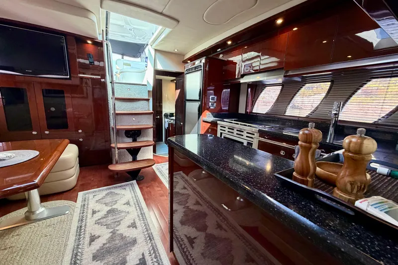  Yacht Photos Pics Luxurious interior of 2009 Sea Ray 48 Sundancer yacht with modern kitchen and seating area.