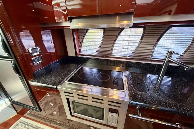  Yacht Photos Pics Luxurious kitchen interior of 2009 Sea Ray 48 Sundancer yacht with modern appliances.