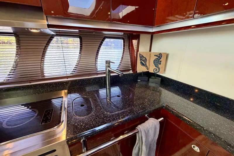  Yacht Photos Pics Luxurious kitchen interior of 2009 Sea Ray 48 Sundancer yacht with sleek countertops.