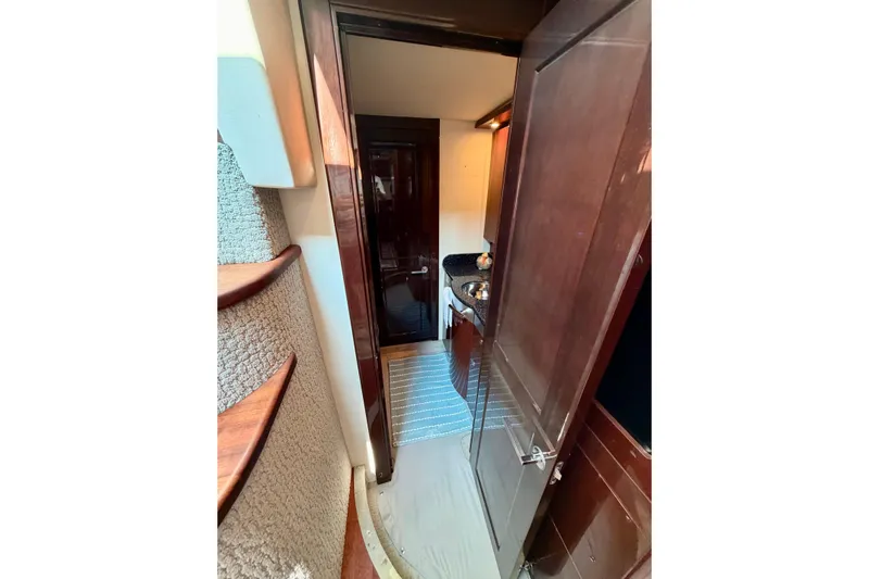  Yacht Photos Pics Interior view of 2009 Sea Ray 48 Sundancer yacht, featuring elegant wood finishes and compact design.