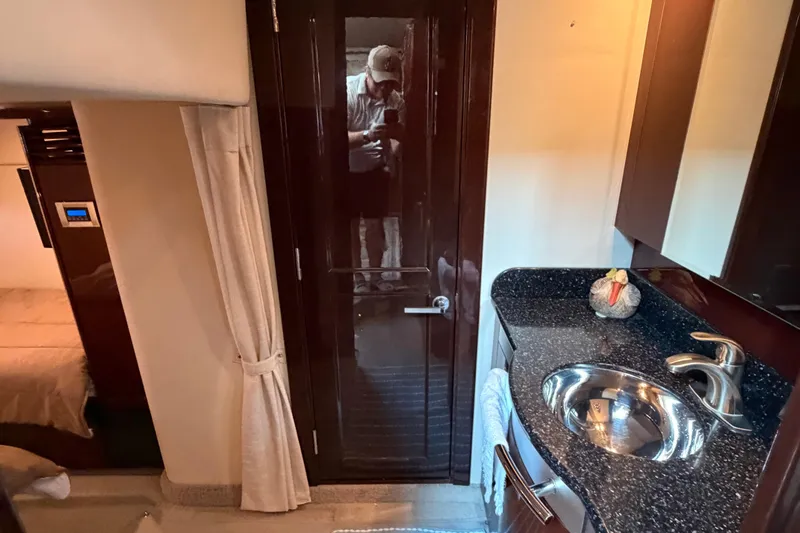  Yacht Photos Pics 2009 Sea Ray 48 Sundancer interior with kitchenette, sink, and dark wood cabinetry.