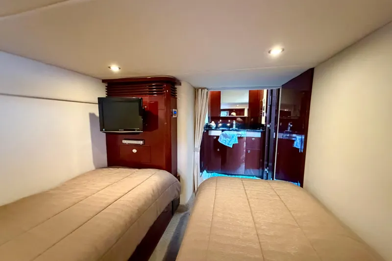 Yacht Photos Pics Interior cabin of 2009 Sea Ray 48 Sundancer yacht with twin beds and TV.