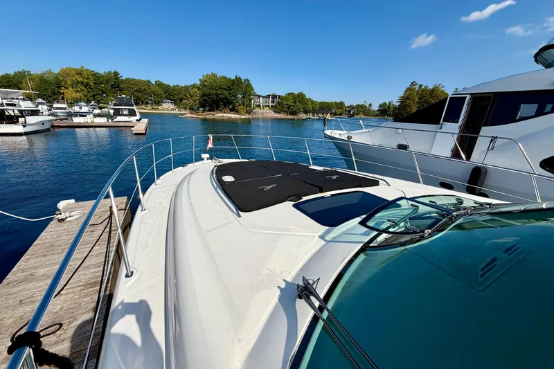  Yacht Photos Pics 2009 Sea Ray 48 Sundancer yacht docked at marina, clear blue sky, calm water.