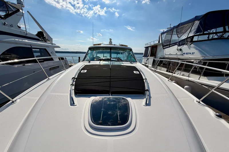  Yacht Photos Pics 2009 Sea Ray 48 Sundancer yacht docked between two boats under a clear sky.