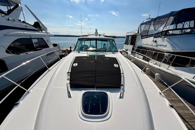  Yacht Photos Pics 2009 Sea Ray 48 Sundancer yacht docked between two boats on a sunny day.