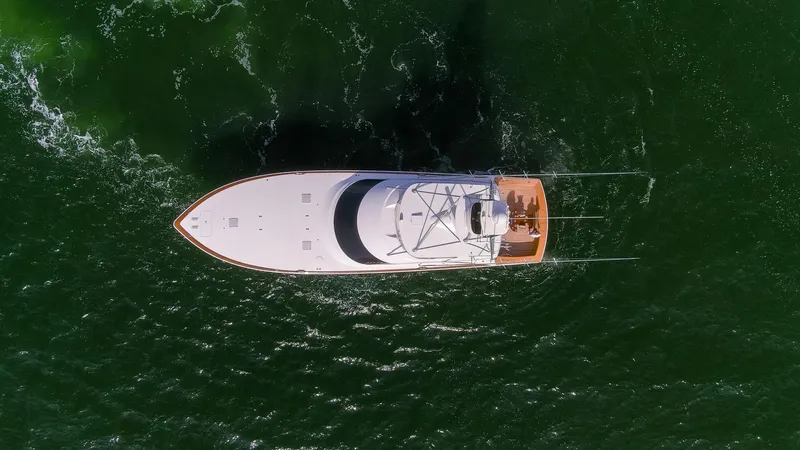Bandito Yacht Photos Pics Aerial view of 2015 Viking 70 Convertible yacht cruising on green water.