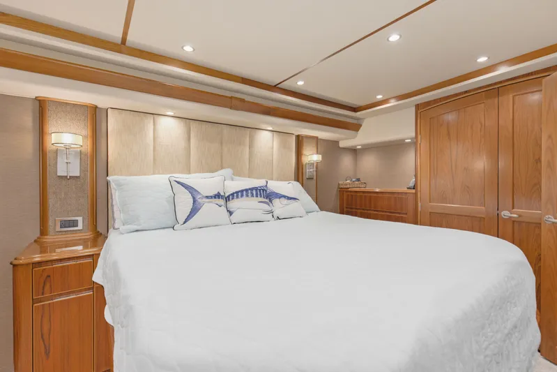 Bandito Yacht Photos Pics Luxurious bedroom interior of 2015 Viking 70 Convertible yacht with elegant wood finishes.