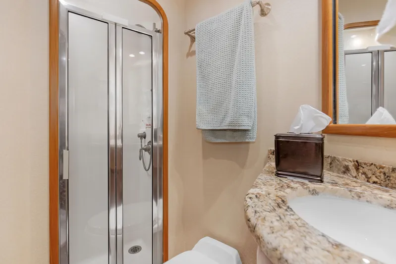 Bandito Yacht Photos Pics Luxurious bathroom in 2015 Viking 70 Convertible yacht with granite countertop and shower.