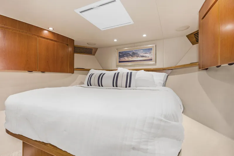 Bandito Yacht Photos Pics Luxurious bedroom interior of 2015 Viking 70 Convertible yacht with elegant wood cabinetry.