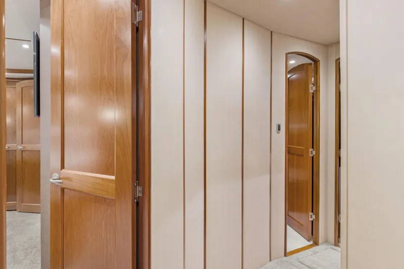 Bandito Yacht Photos Pics Interior hallway of 2015 Viking 70 Convertible yacht with wooden doors and paneling.