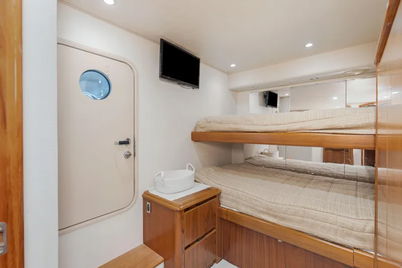 Bandito Yacht Photos Pics Interior of 2015 Viking 70 Convertible yacht with bunk beds and TV.