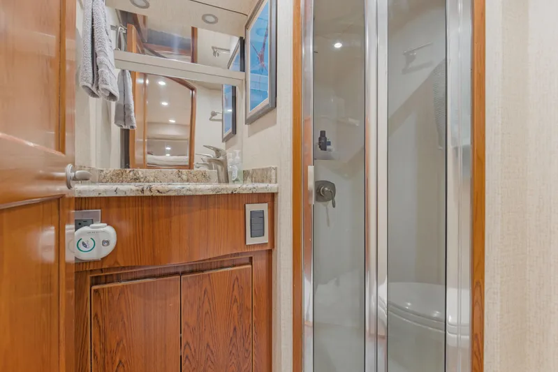 Bandito Yacht Photos Pics Luxurious bathroom in 2015 Viking 70 Convertible yacht with wood cabinetry and glass shower.