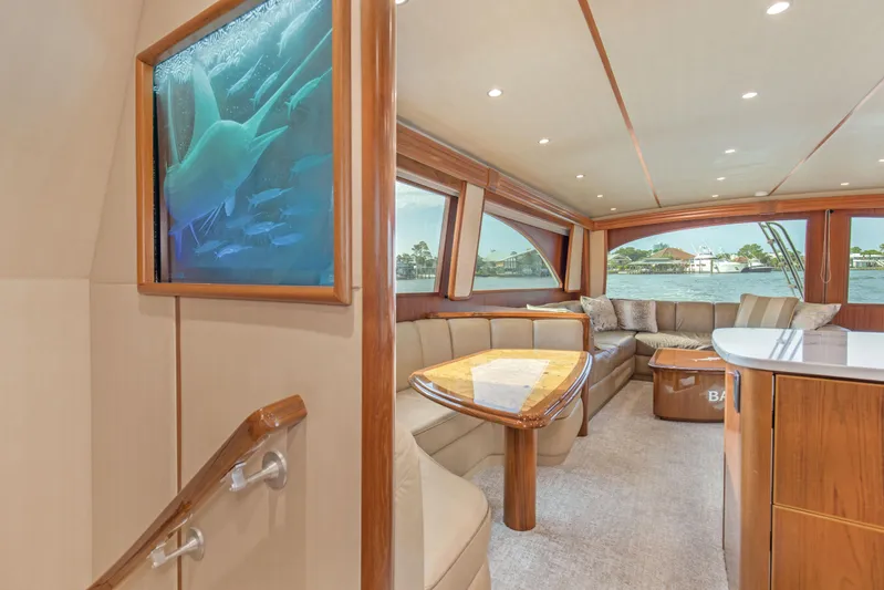 Bandito Yacht Photos Pics Luxurious interior of 2015 Viking 70 Convertible yacht with elegant seating and large windows.