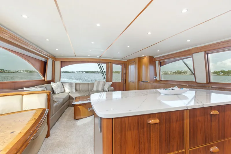 Bandito Yacht Photos Pics Luxurious interior of 2015 Viking 70 Convertible yacht with elegant wood finishes and panoramic windows.