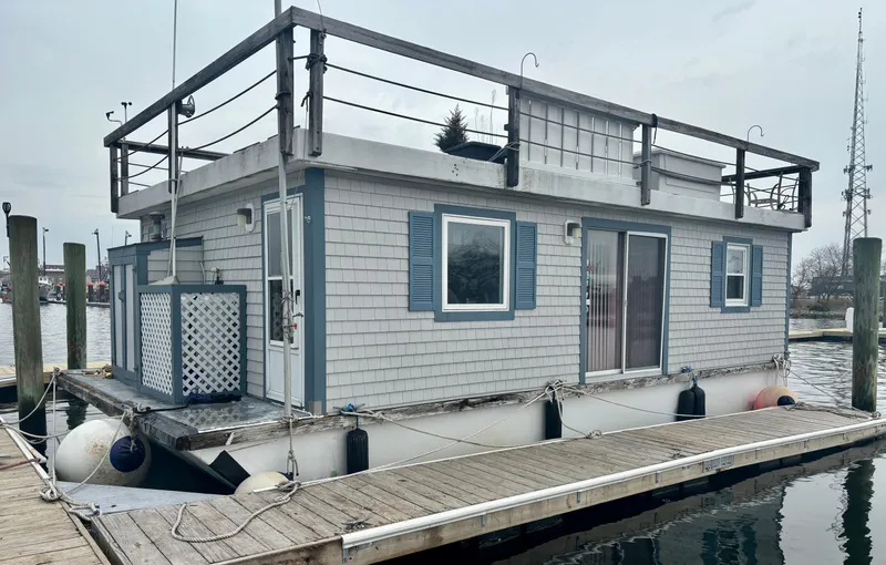  Yacht Photos Pics Custom 1990 houseboat docked, featuring blue shutters and a rooftop deck.