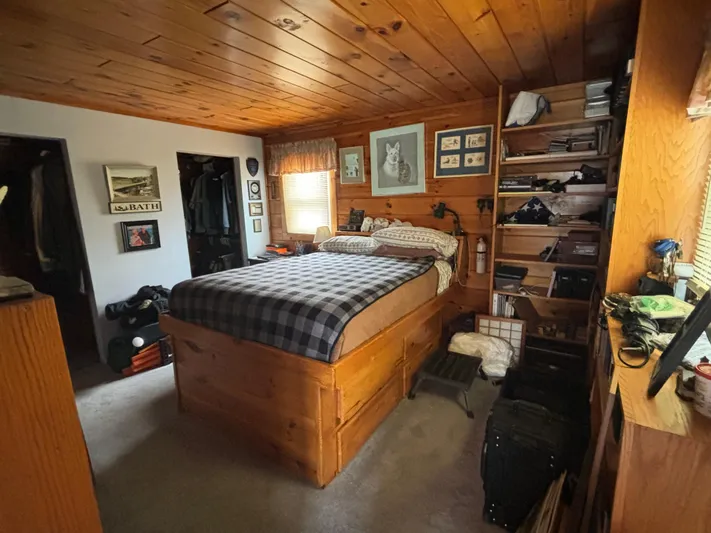  Yacht Photos Pics Cozy wooden bedroom on a 1990 custom houseboat with plaid bedding and wall art.