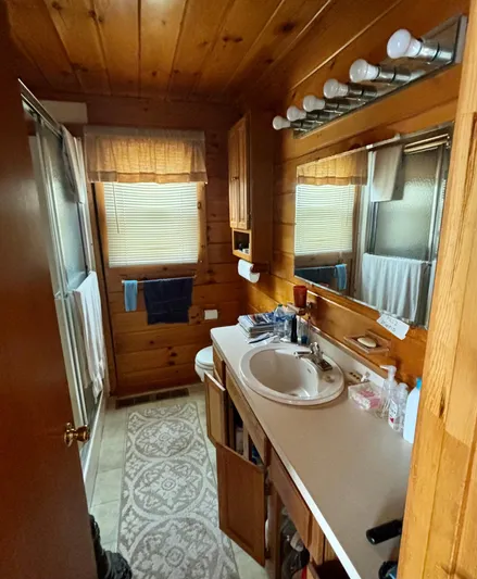  Yacht Photos Pics Wood-paneled houseboat bathroom with sink, mirror, and natural light, Custom model, 1990.