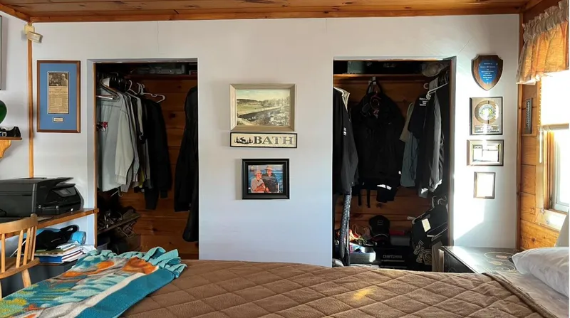  Yacht Photos Pics Cozy houseboat bedroom with wooden accents, dual closets, and framed wall art.