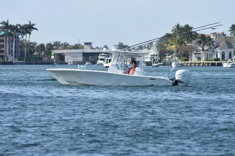 Pamela Ann Yacht Photos Pics 2017 Conch 30 boat cruising on a sunny day near waterfront homes.