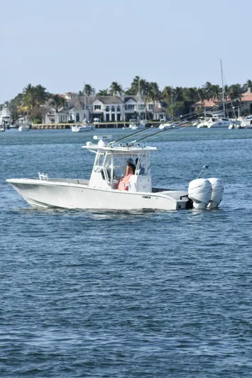 Pamela Ann Yacht Photos Pics 2017 Conch 30 boat cruising on a sunny day near waterfront homes.