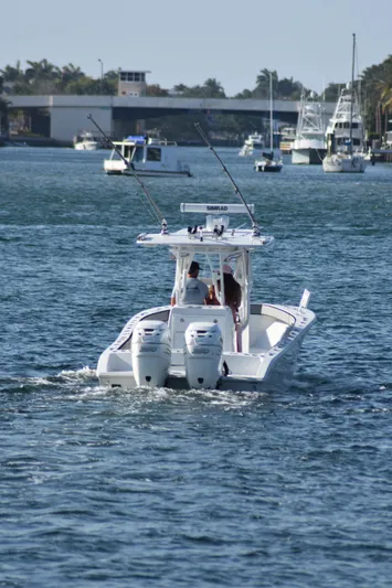 Pamela Ann Yacht Photos Pics 2017 Conch 30 boat cruising on a sunny day with fishing rods.