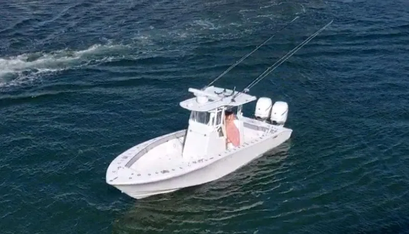 Pamela Ann Yacht Photos Pics 2018 Conch 30 boat on open water with dual engines and fishing rods.