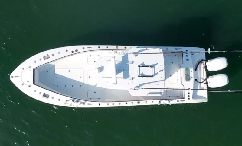 Pamela Ann Yacht Photos Pics Aerial view of 2018 Conch 30 boat on water, showcasing sleek design and twin engines.