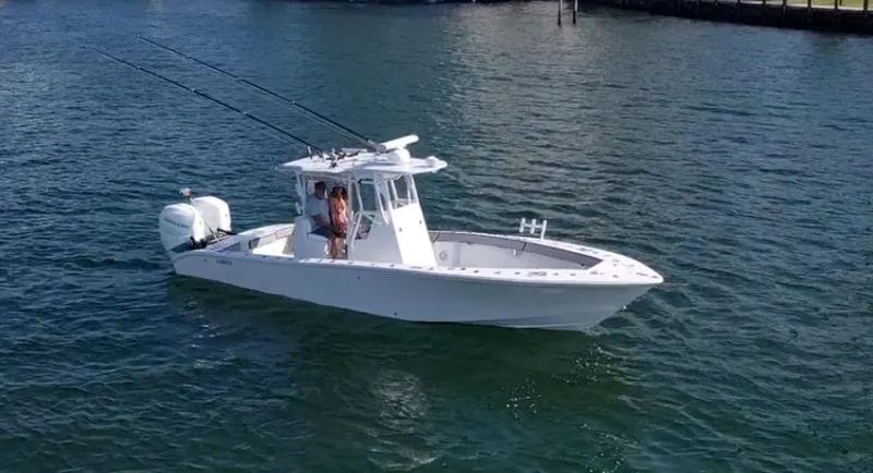 Pamela Ann Yacht Photos Pics 2018 Conch 30 boat on water, equipped with fishing rods and dual engines.