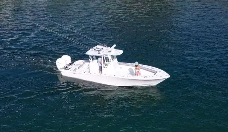 Pamela Ann Yacht Photos Pics 2018 Conch 30 boat cruising on open water with fishing rods.