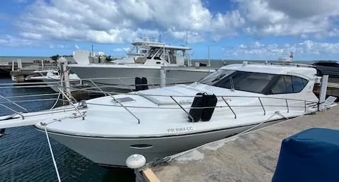 Yacht Photos Pics 2013 Uniesse 49 EXPRESS yacht docked at marina under blue sky.