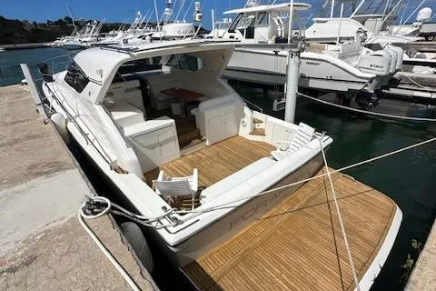  Yacht Photos Pics 2013 Uniesse 49 EXPRESS yacht docked, featuring spacious deck and seating area.