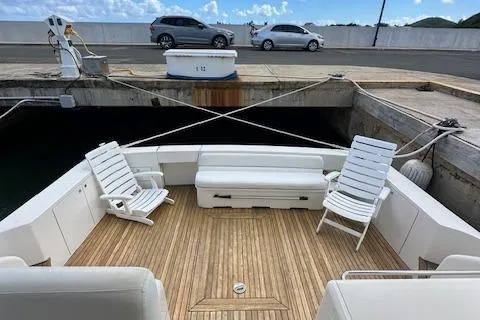  Yacht Photos Pics 2013 Uniesse 49 EXPRESS yacht with spacious deck, white seating, and wooden flooring.