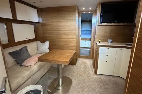  Yacht Photos Pics Luxurious interior of 2013 Uniesse 49 EXPRESS yacht with cozy seating and modern amenities.